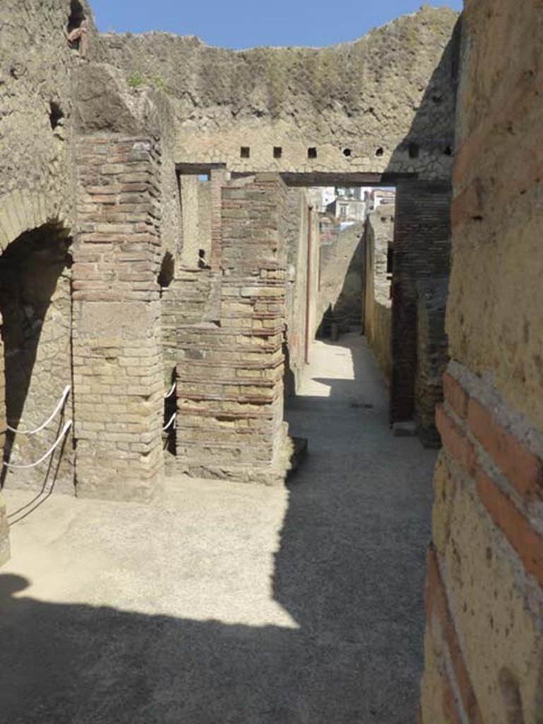 VI.10, Herculaneum. June 2014. Looking west from entrance doorway along corridor at rear of men’s central baths. Photo courtesy of Michael Binns.
